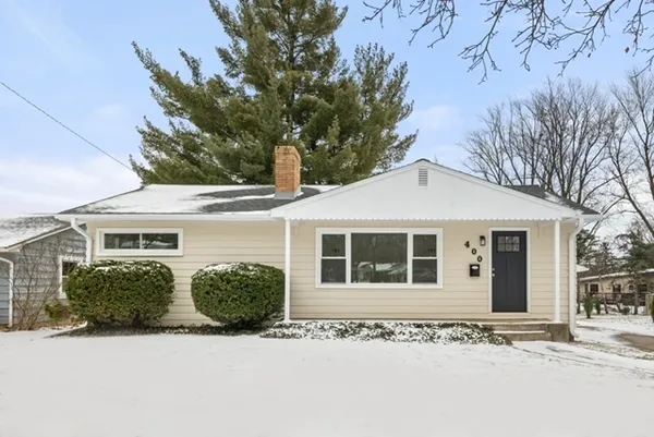 a front view of a house with a garden