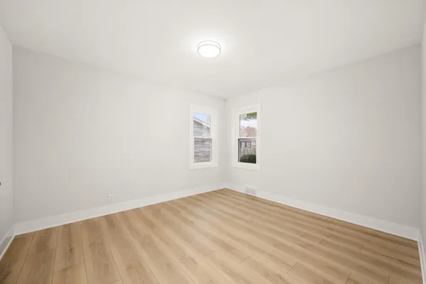 a view of a room with wooden floor and fan