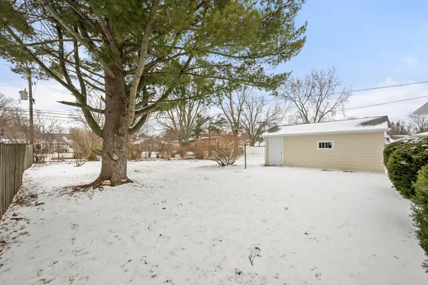 a view of a yard covered in snow