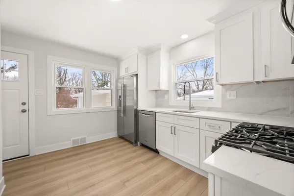 a kitchen with a sink stove and cabinets