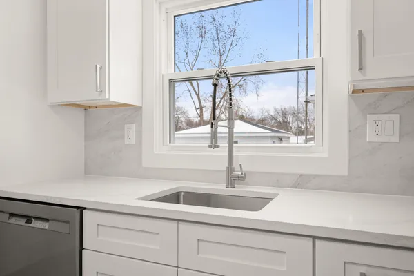 a kitchen with a sink and cabinets