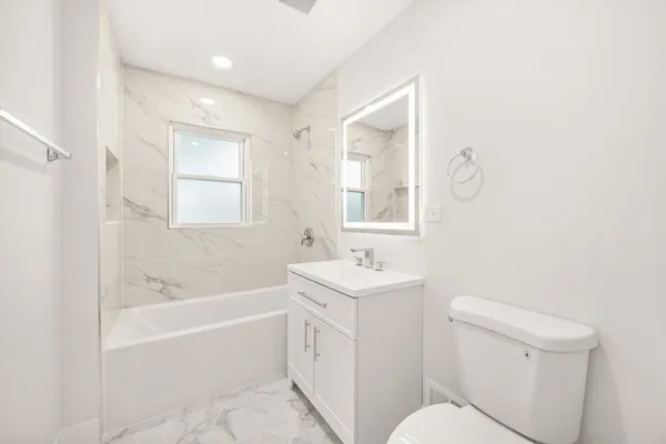 a bathroom with a toilet a sink and bathtub