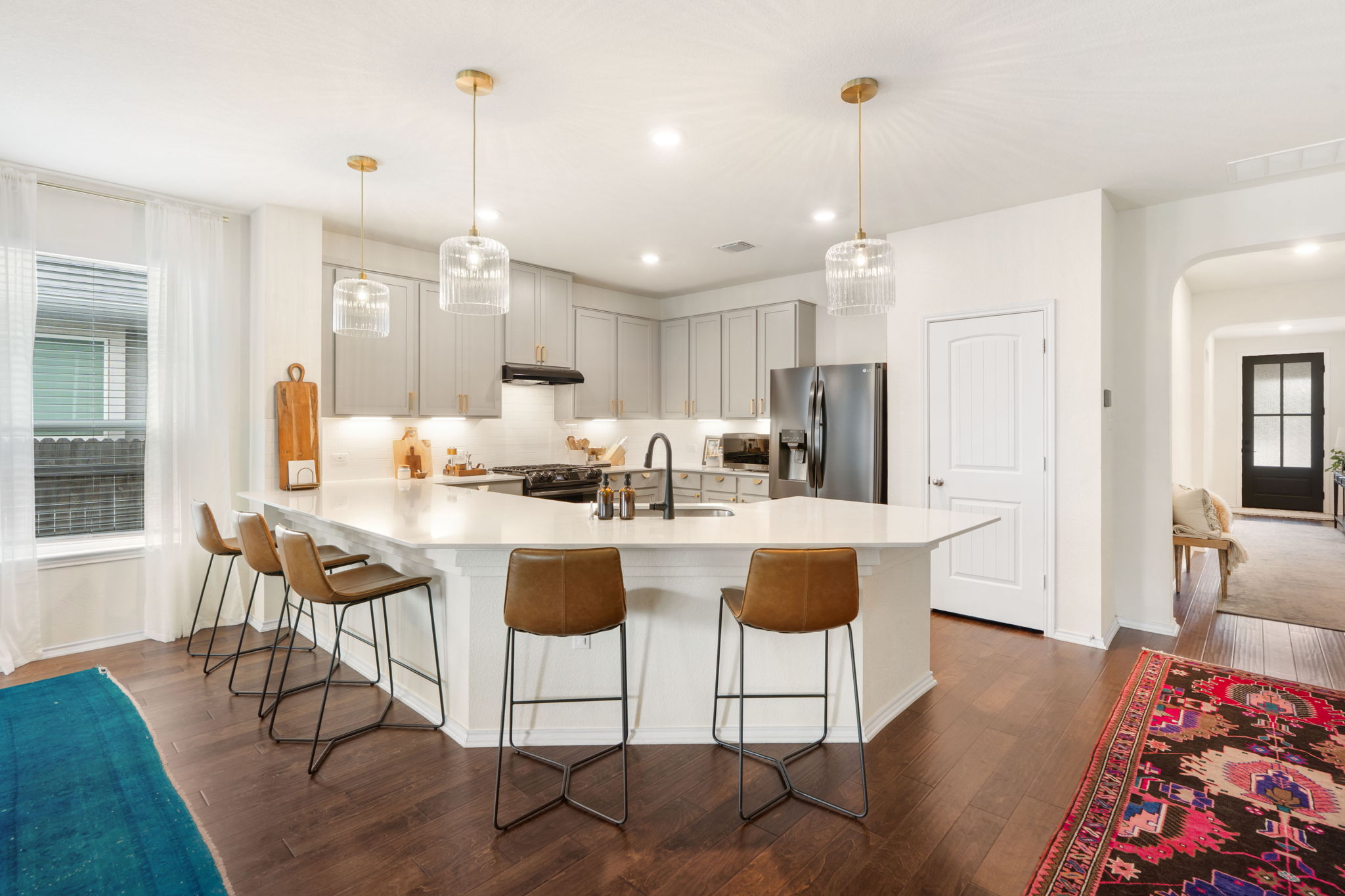 109 Vickers Street Georgetown, TX 78628 - Photo 1 of 1 Extended bar seating around kitchen and custom pendant lighting