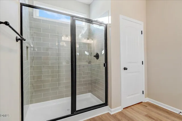 a bathroom with a glass shower door