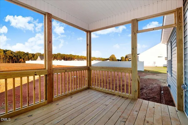 a view of a balcony with wooden floor