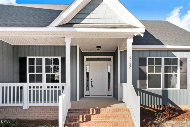 a front view of a house with large windows