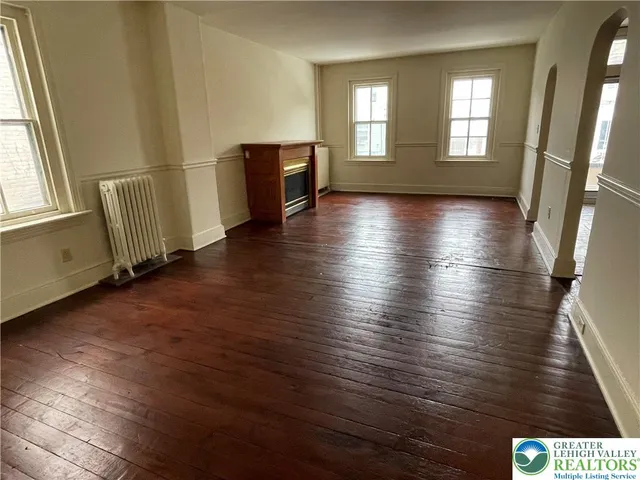 a view of a room with wooden floor and window