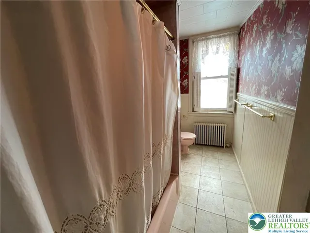 a view of a bathroom with a shower curtain