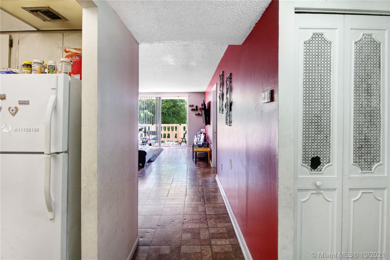 15600 Northwest 7th Avenue, Unit 3011 Miami, FL 33169 - Photo 2 of 30 a view of hallway with cabinets and wooden floor