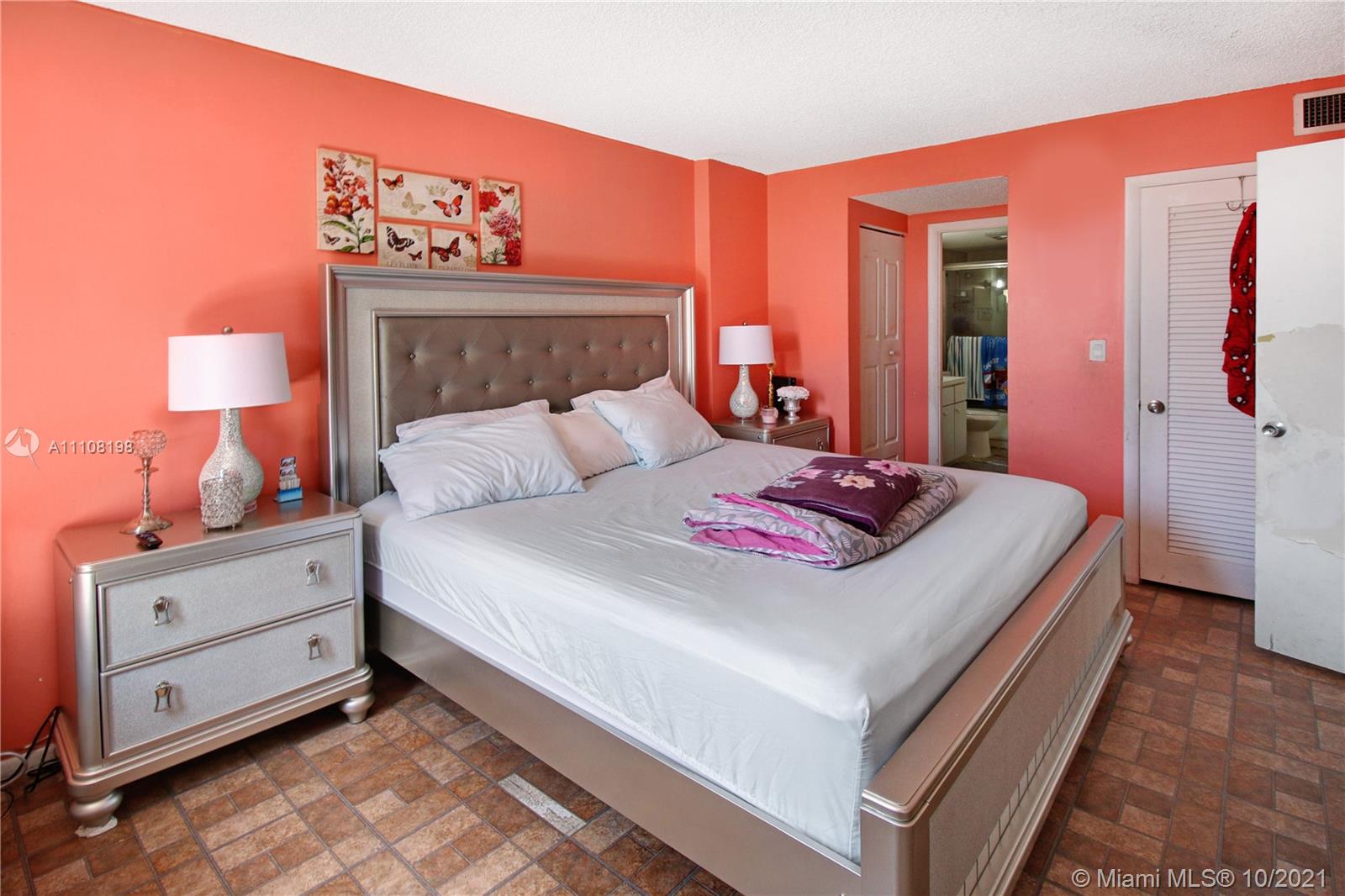 15600 Northwest 7th Avenue, Unit 3011 Miami, FL 33169 - Photo 15 of 30 a bedroom with a bed and a night stand