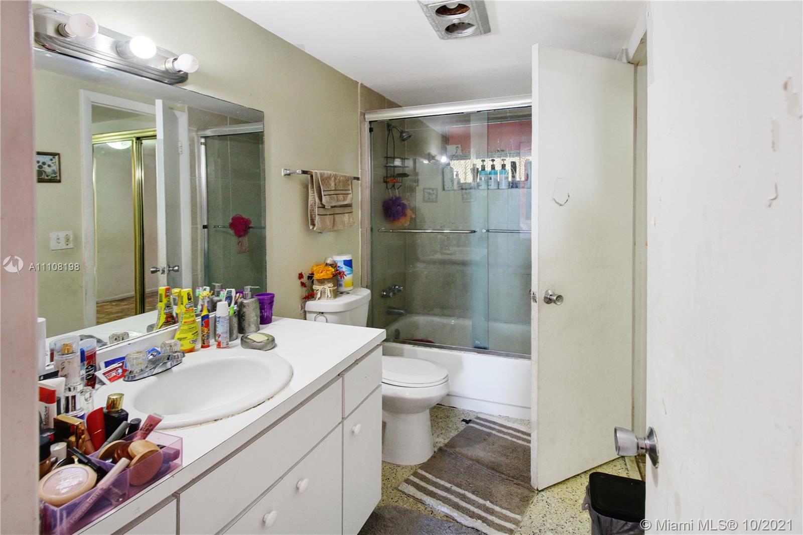 15600 Northwest 7th Avenue, Unit 3011 Miami, FL 33169 - Photo 17 of 30 a bathroom with a sink vanity mirror and toilet
