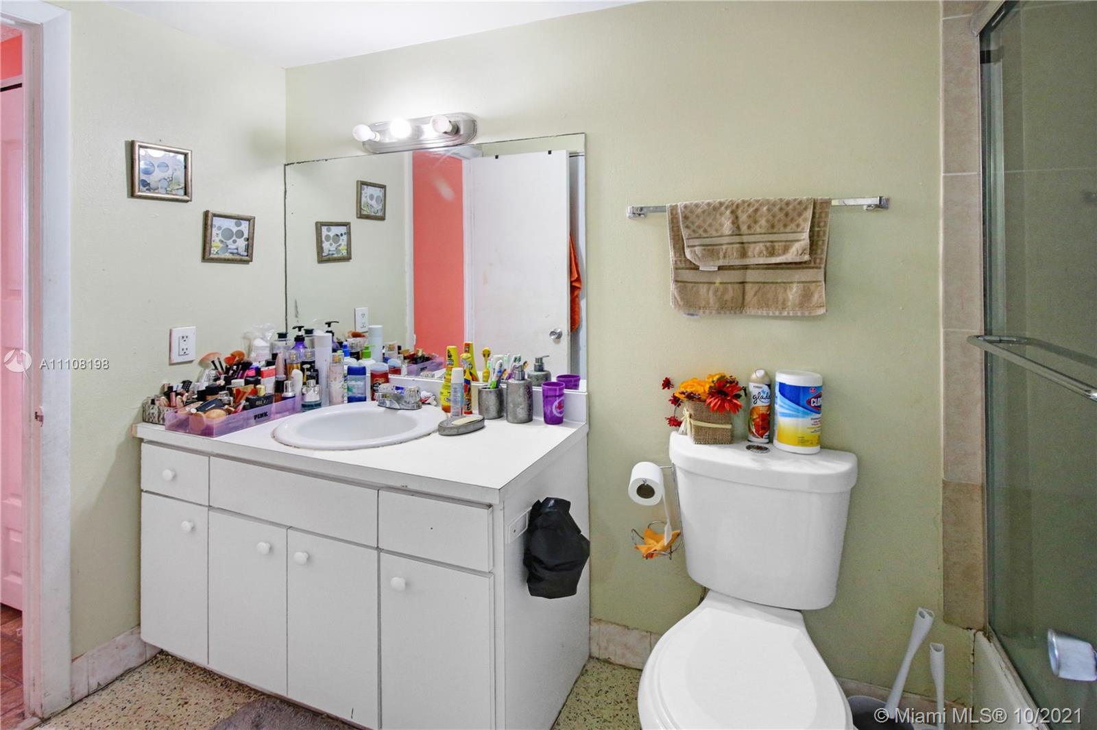 15600 Northwest 7th Avenue, Unit 3011 Miami, FL 33169 - Photo 18 of 30 a bathroom with a sink mirror vanity and toilet