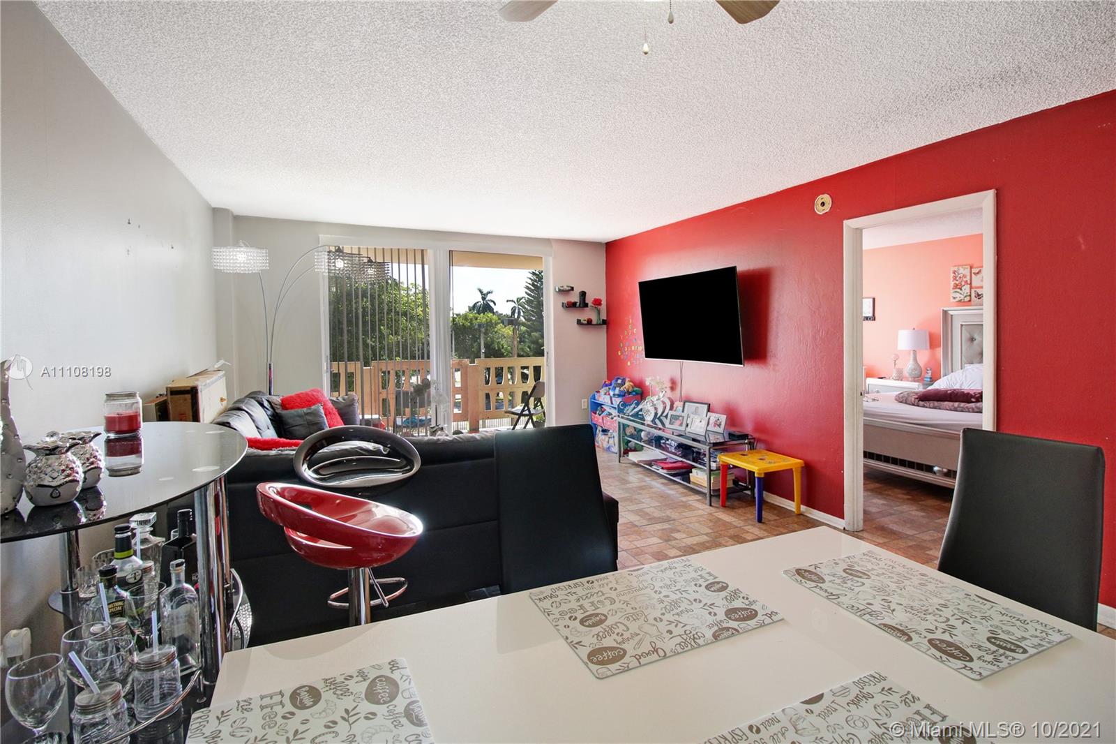 15600 Northwest 7th Avenue, Unit 3011 Miami, FL 33169 - Photo 3 of 30 a living room with furniture and a flat screen tv