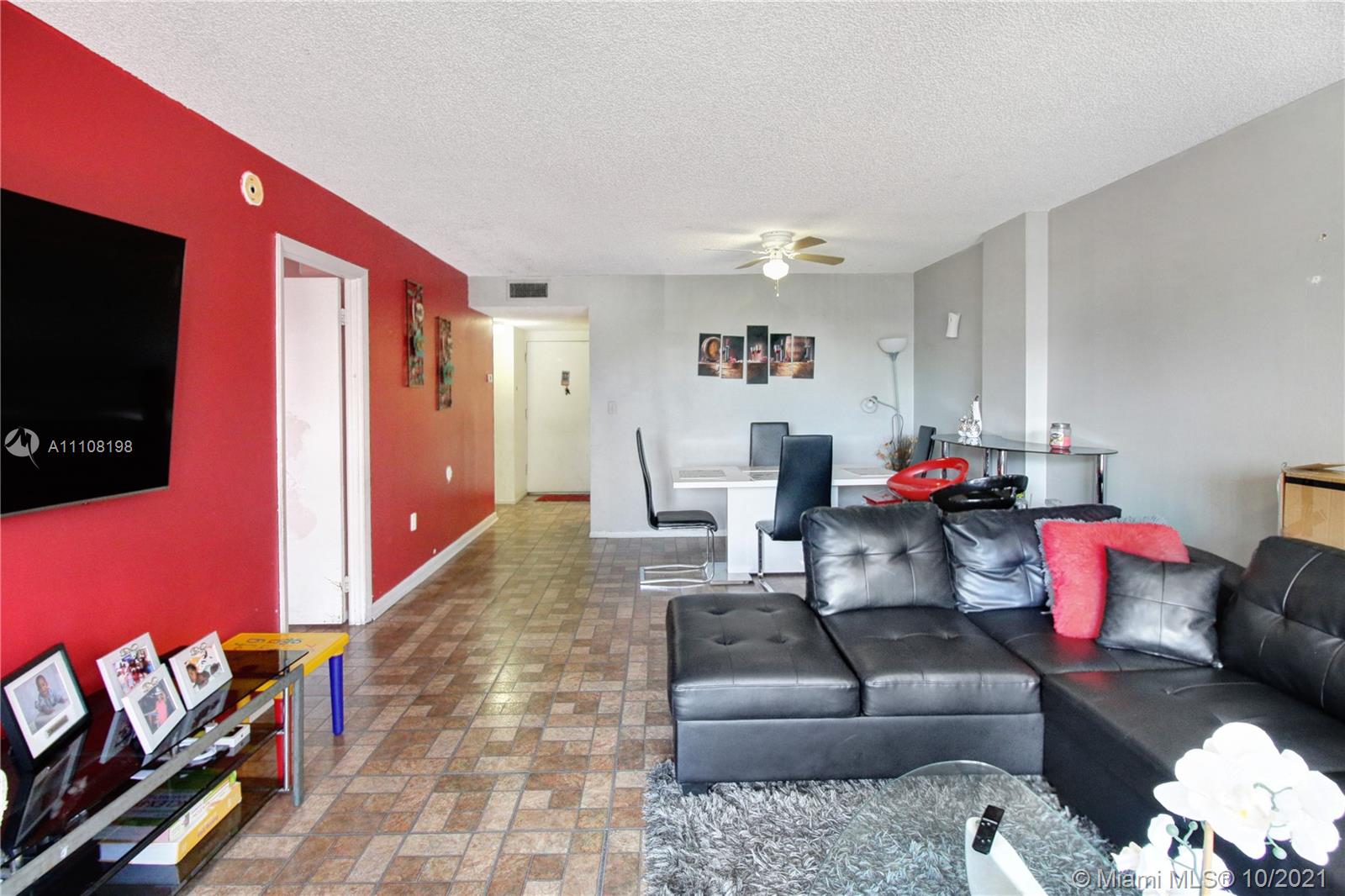 15600 Northwest 7th Avenue, Unit 3011 Miami, FL 33169 - Photo 7 of 30 a living room with furniture and a flat screen tv