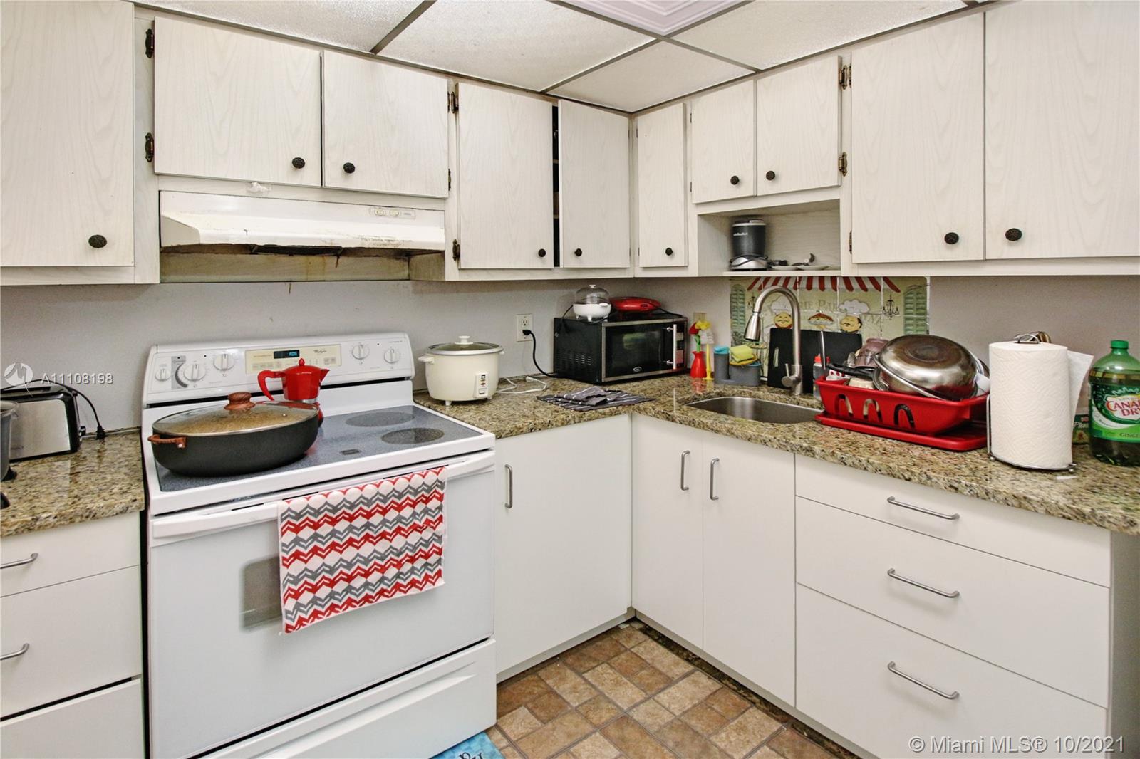 15600 Northwest 7th Avenue, Unit 3011 Miami, FL 33169 - Photo 10 of 30 a kitchen with stainless steel appliances granite countertop a sink a stove and cabinets