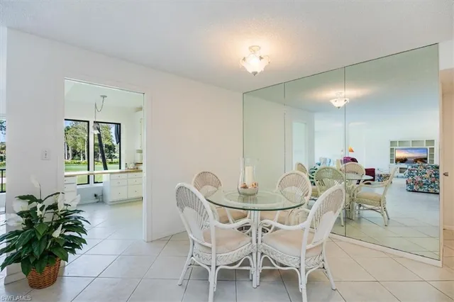 a view of a dining room with furniture and a potted plant