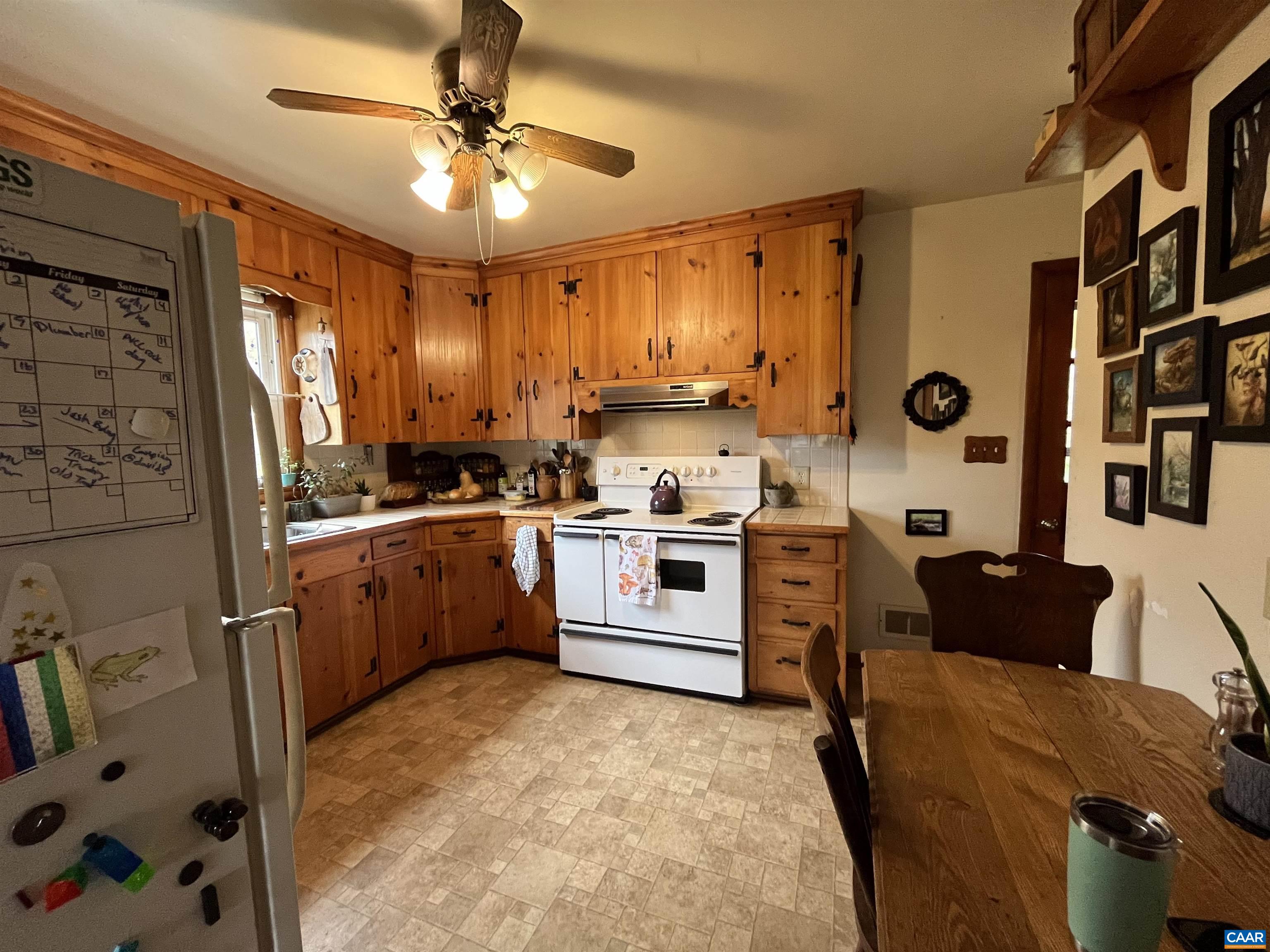 1839 Afton Mountain Road Afton, VA 22920 - Photo 8 of 11 a kitchen with stainless steel appliances granite countertop a stove a sink dishwasher and a refrigerator with wooden floor