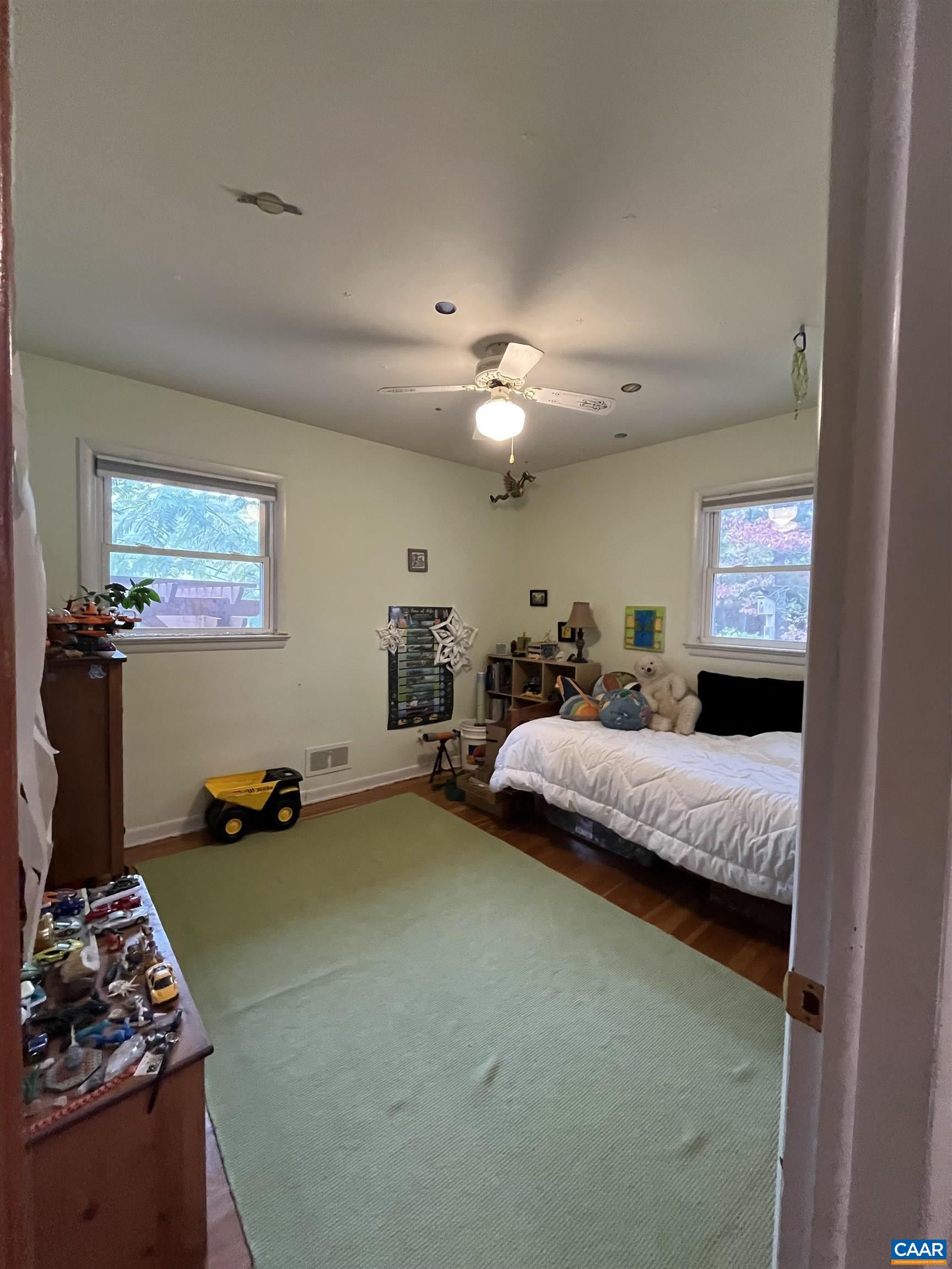 1839 Afton Mountain Road Afton, VA 22920 - Photo 10 of 11 a bedroom with a bed and a chandelier