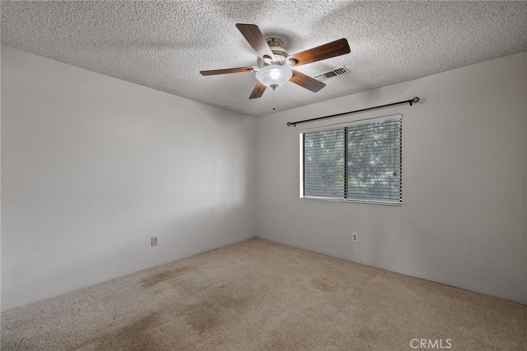 2065 Jenkins Road Bakersfield, CA 93314 - Photo 59 of 59 an empty room with ceiling fan and windows