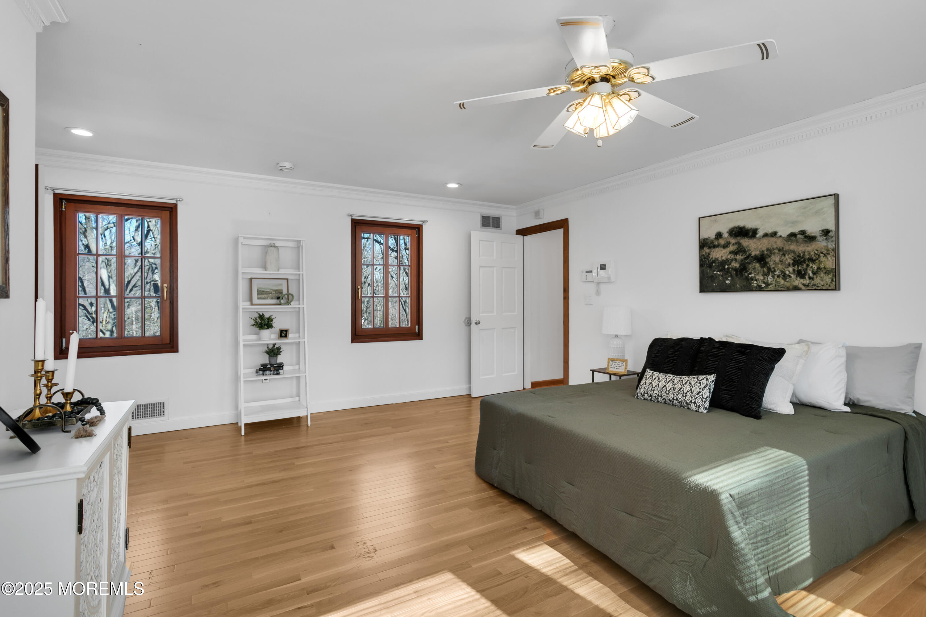 160 Pelican Road Middletown, NJ 07748 - Photo 34 of 65 a bedroom with a large bed and a chandelier