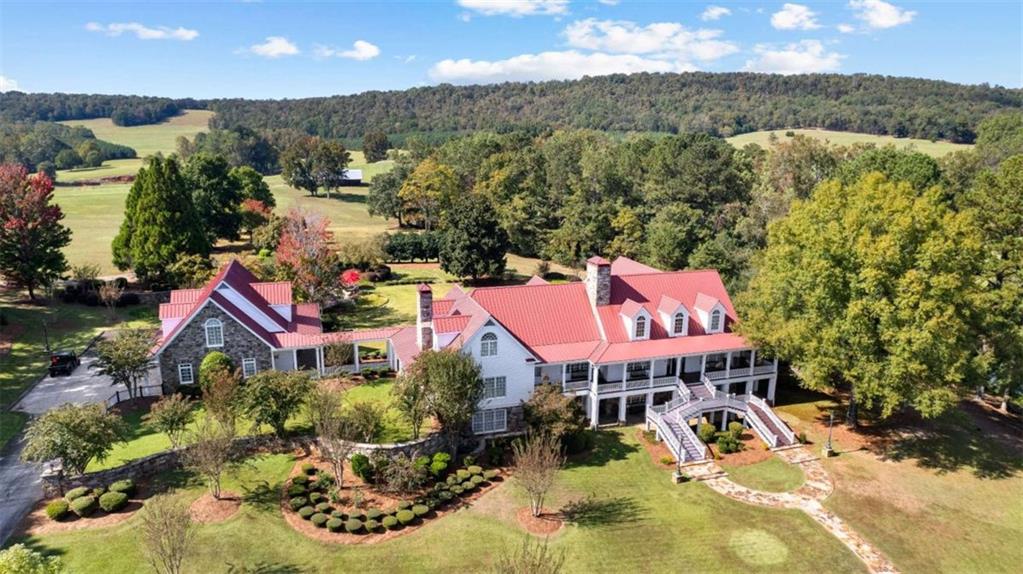 5225 Chalybeate Springs Road Woodland, GA 31836 - Photo 49 of 100 an aerial view of a house with swimming pool and mountains