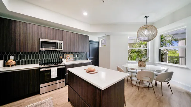 a kitchen with a table chairs stove and microwave