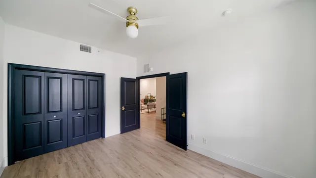 a view of a hall with wooden floor and a window