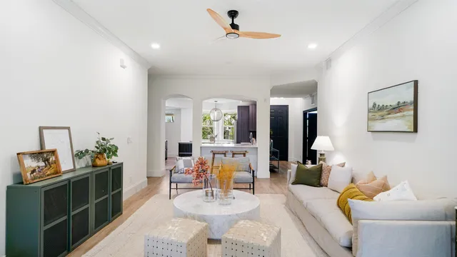 a living room with furniture and wooden floor