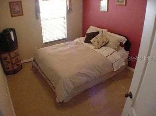 1237 Portmoor Way Winter Garden, FL 34787 - Photo 8 of 9 a bedroom with a bed and a window
