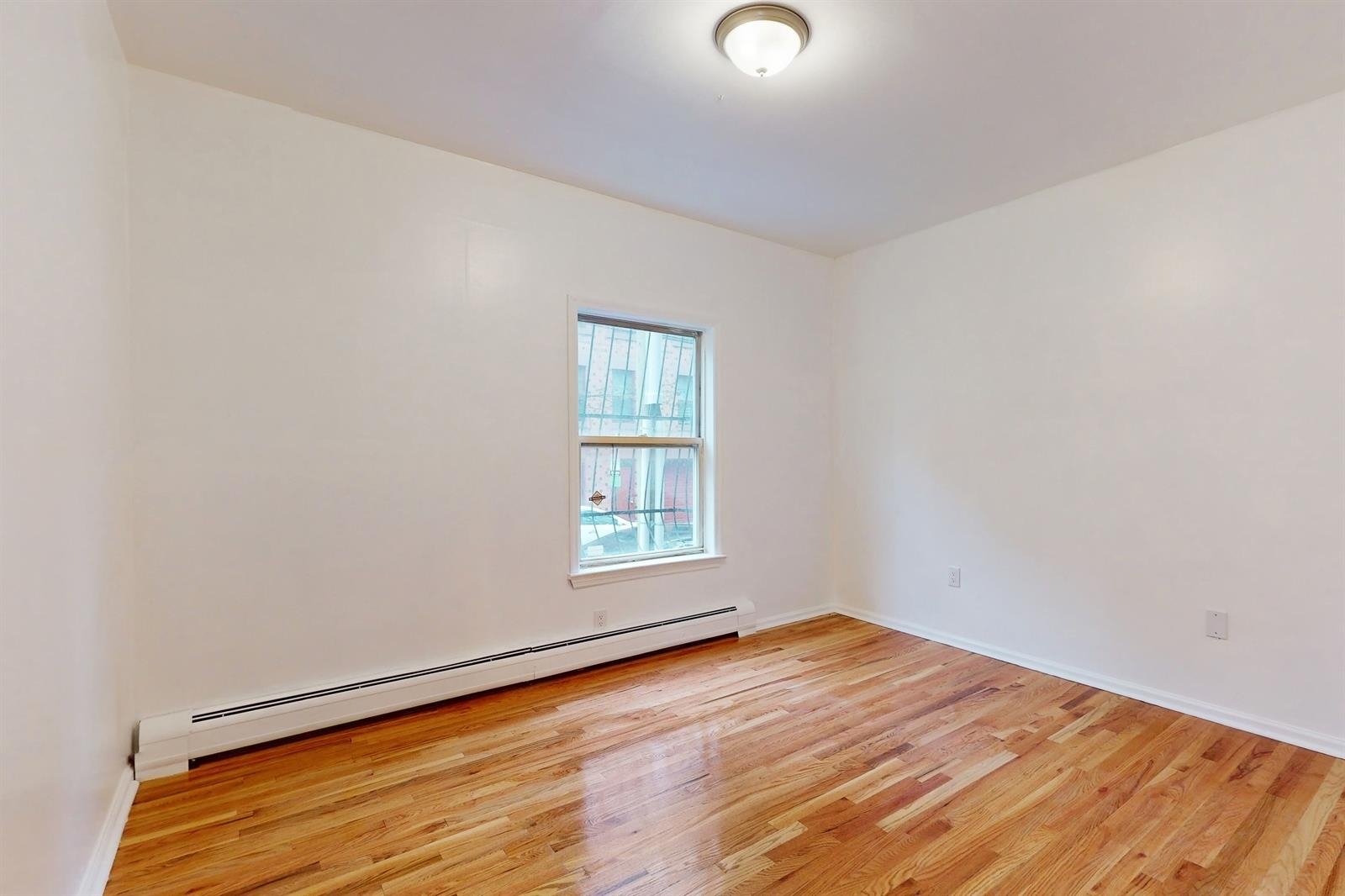 604 4th Street Hoboken, NJ 07030 - Photo 11 of 30 an empty room with wooden floor and windows