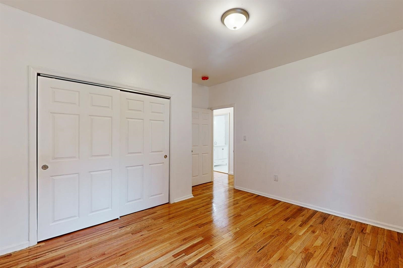 604 4th Street Hoboken, NJ 07030 - Photo 12 of 30 a view of an empty room with wooden floor