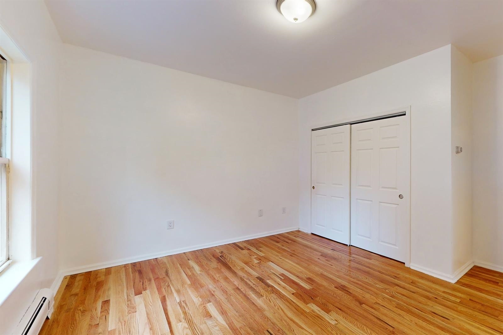 604 4th Street Hoboken, NJ 07030 - Photo 13 of 30 a view of empty room with wooden floor