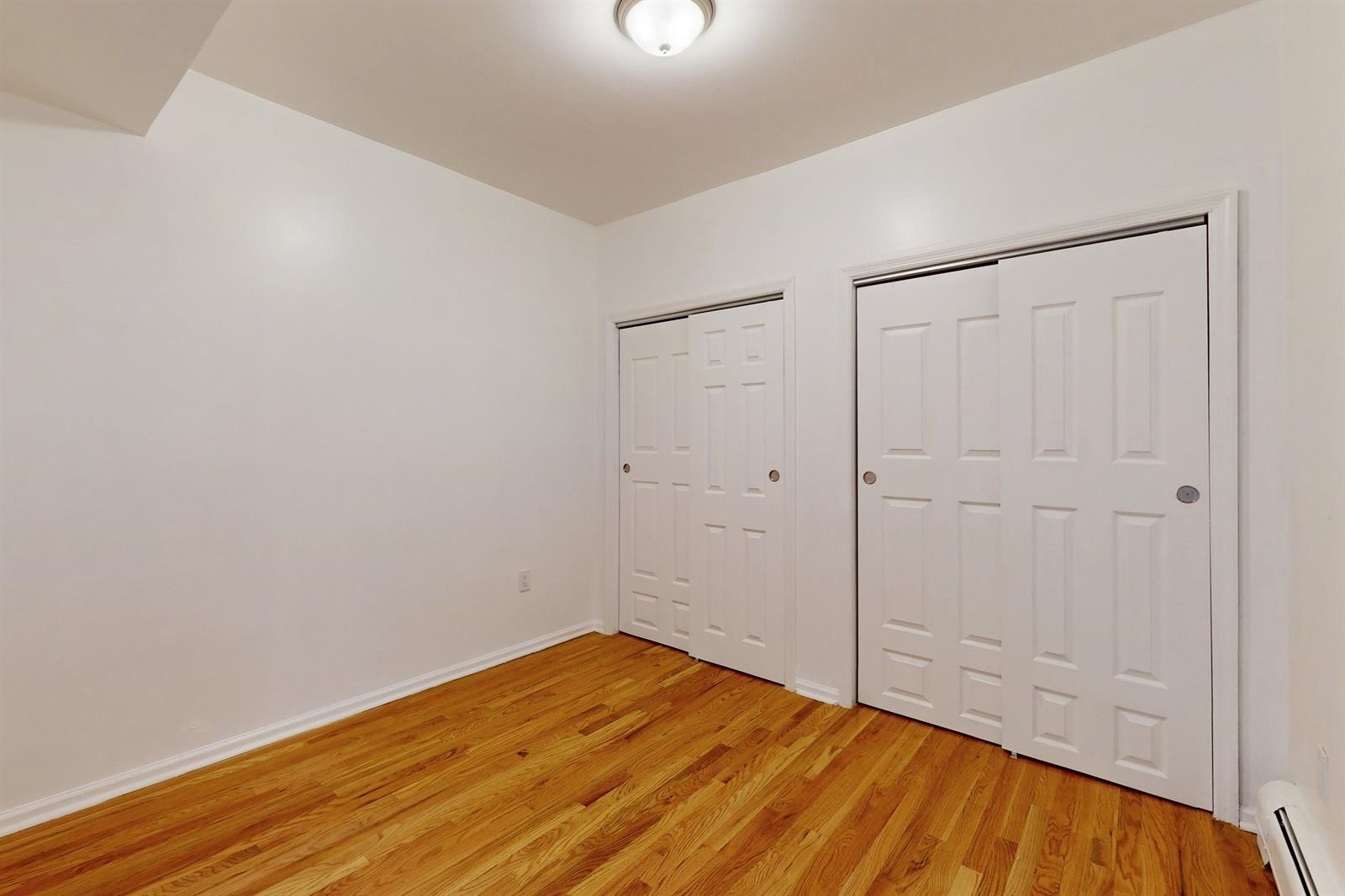 604 4th Street Hoboken, NJ 07030 - Photo 14 of 30 a view of empty room with wooden floor