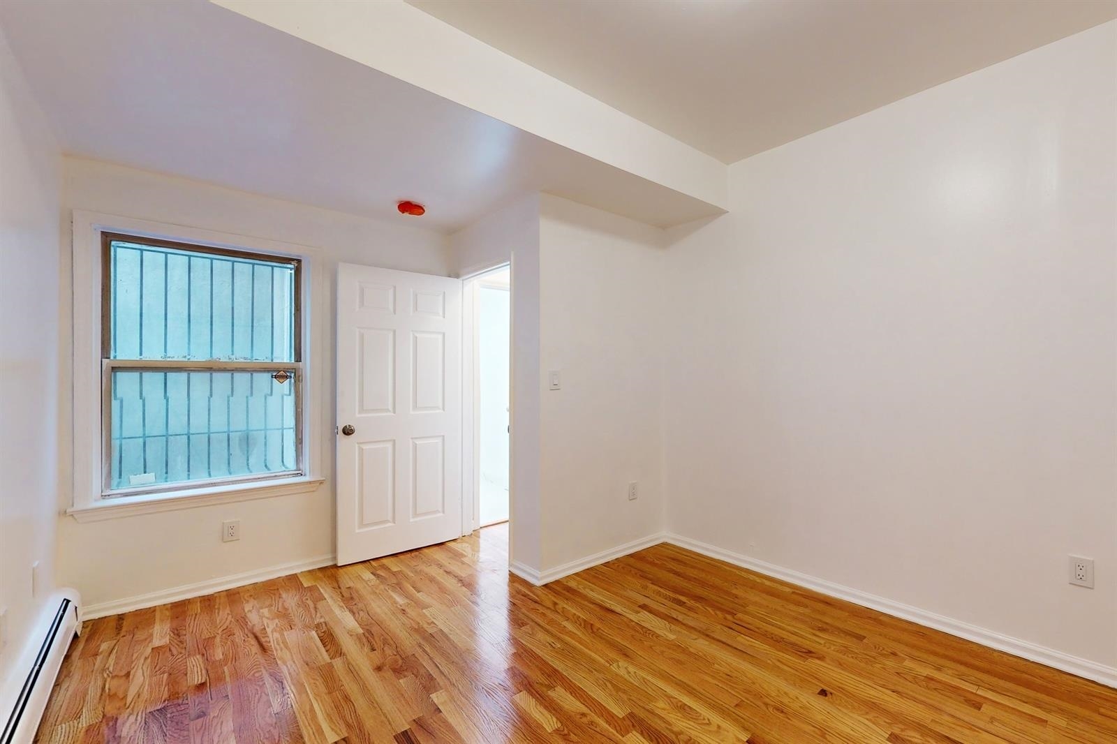604 4th Street Hoboken, NJ 07030 - Photo 15 of 30 a view of room with window and wooden floor