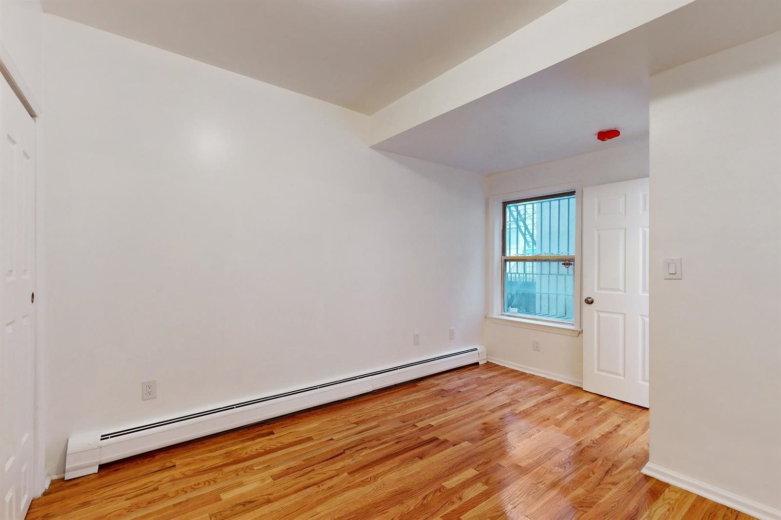 604 4th Street Hoboken, NJ 07030 - Photo 16 of 30 an empty room with wooden floor and windows