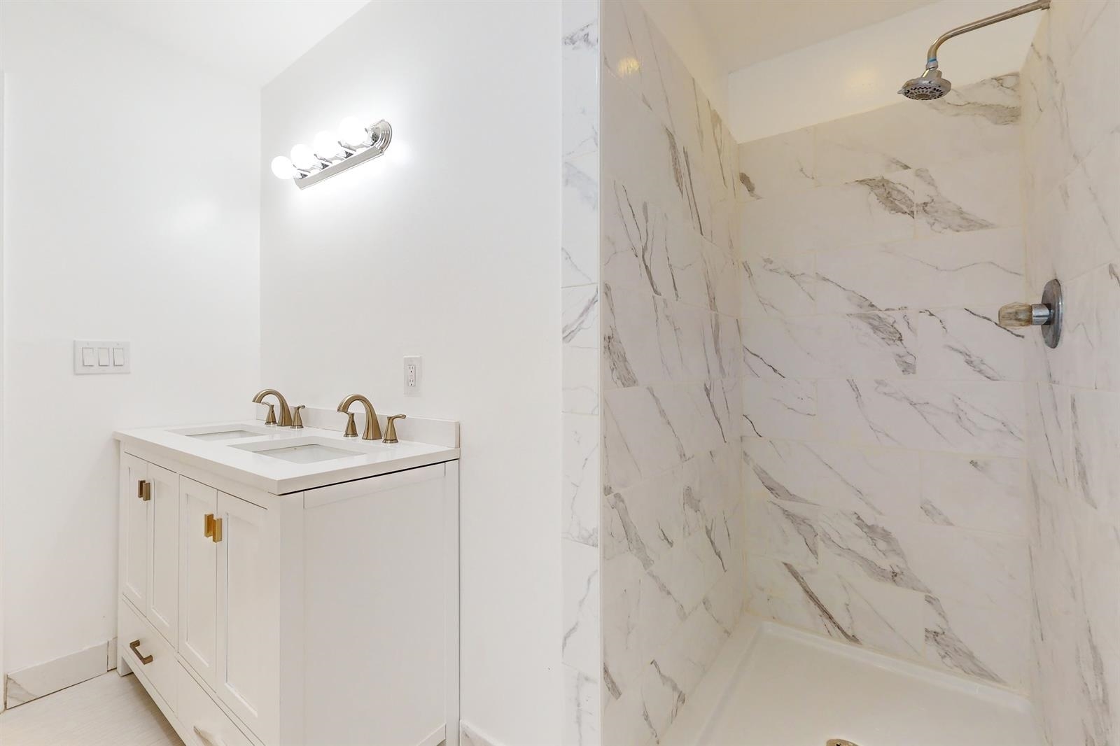 604 4th Street Hoboken, NJ 07030 - Photo 18 of 30 a bathroom with a sink and a mirror