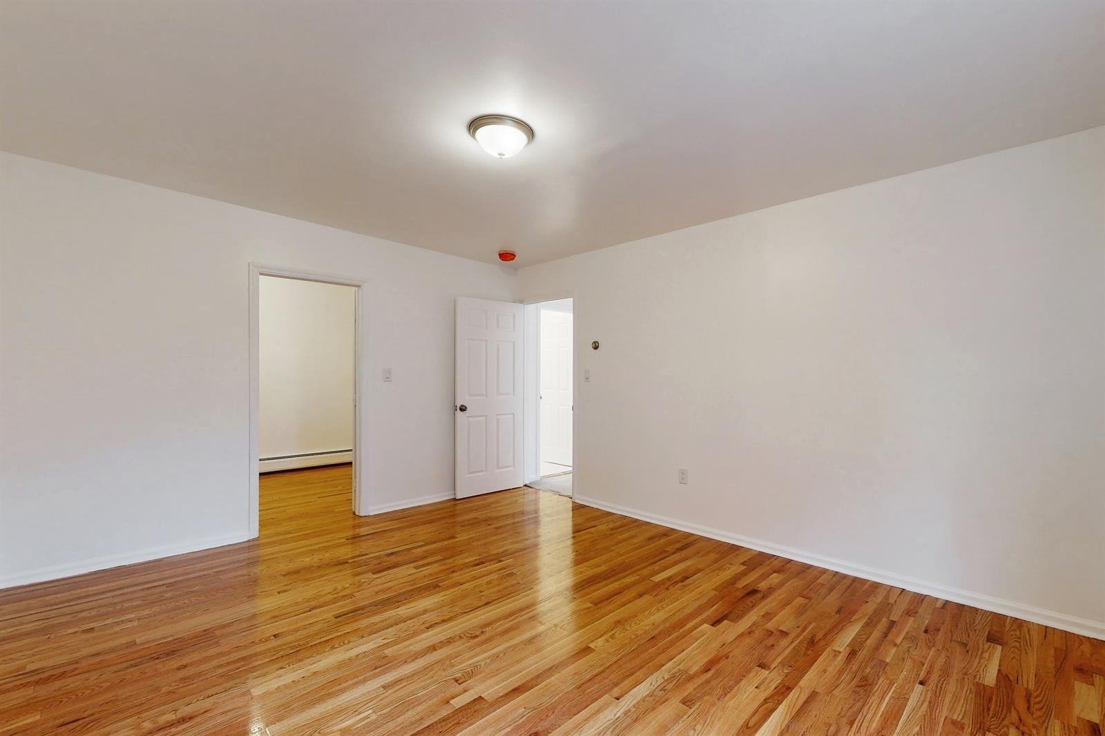 604 4th Street Hoboken, NJ 07030 - Photo 22 of 30 a view of an empty room with wooden floor