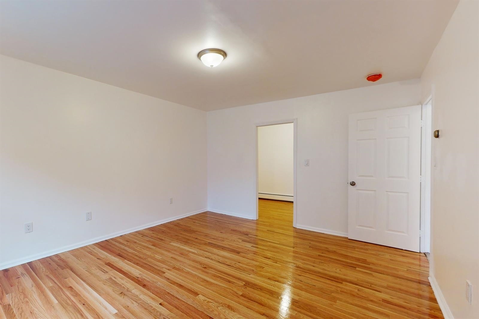 604 4th Street Hoboken, NJ 07030 - Photo 24 of 30 a view of empty room with wooden floor and fan