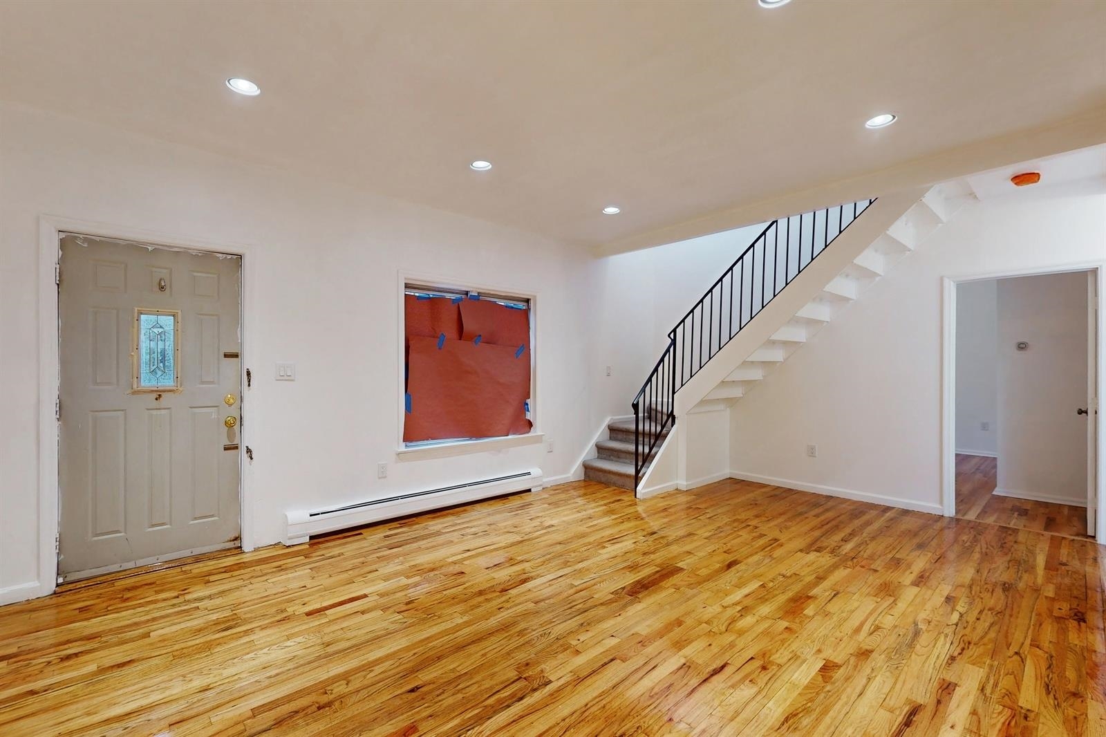 604 4th Street Hoboken, NJ 07030 - Photo 4 of 30 a view of an empty room with wooden floor and stairs