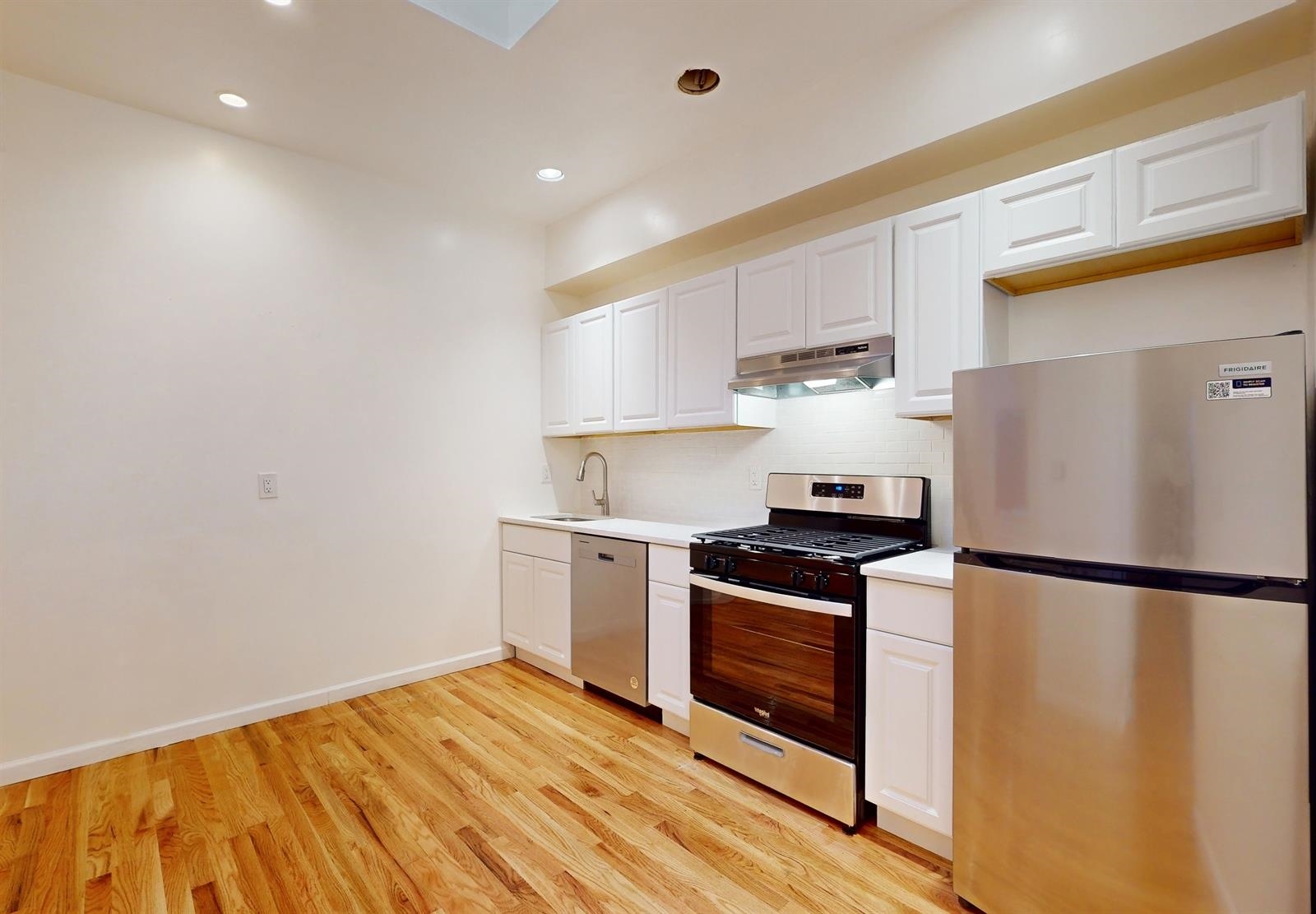 604 4th Street Hoboken, NJ 07030 - Photo 7 of 30 a kitchen with a refrigerator and a stove top oven