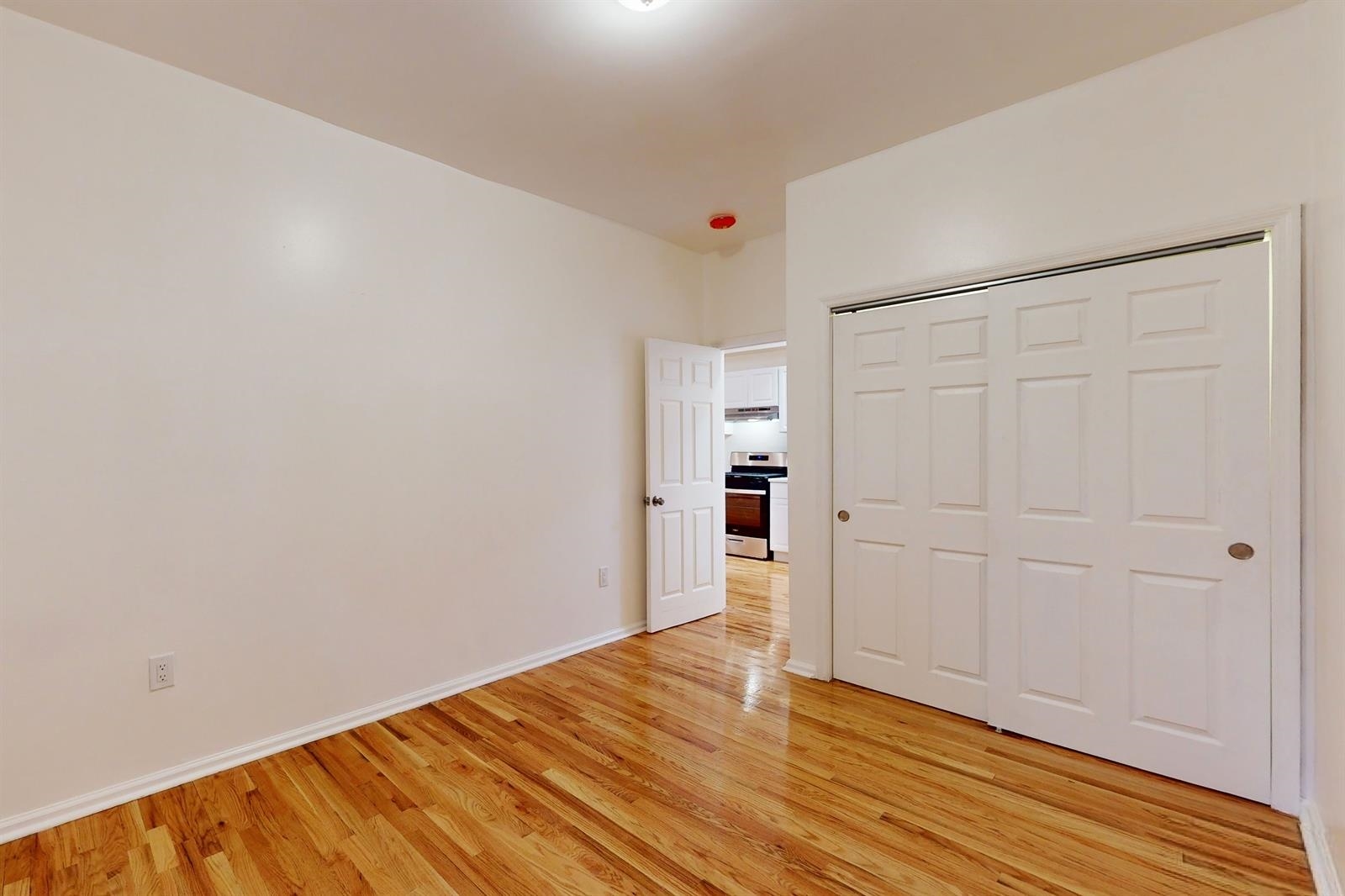 604 4th Street Hoboken, NJ 07030 - Photo 9 of 30 a view of an empty room with wooden floor