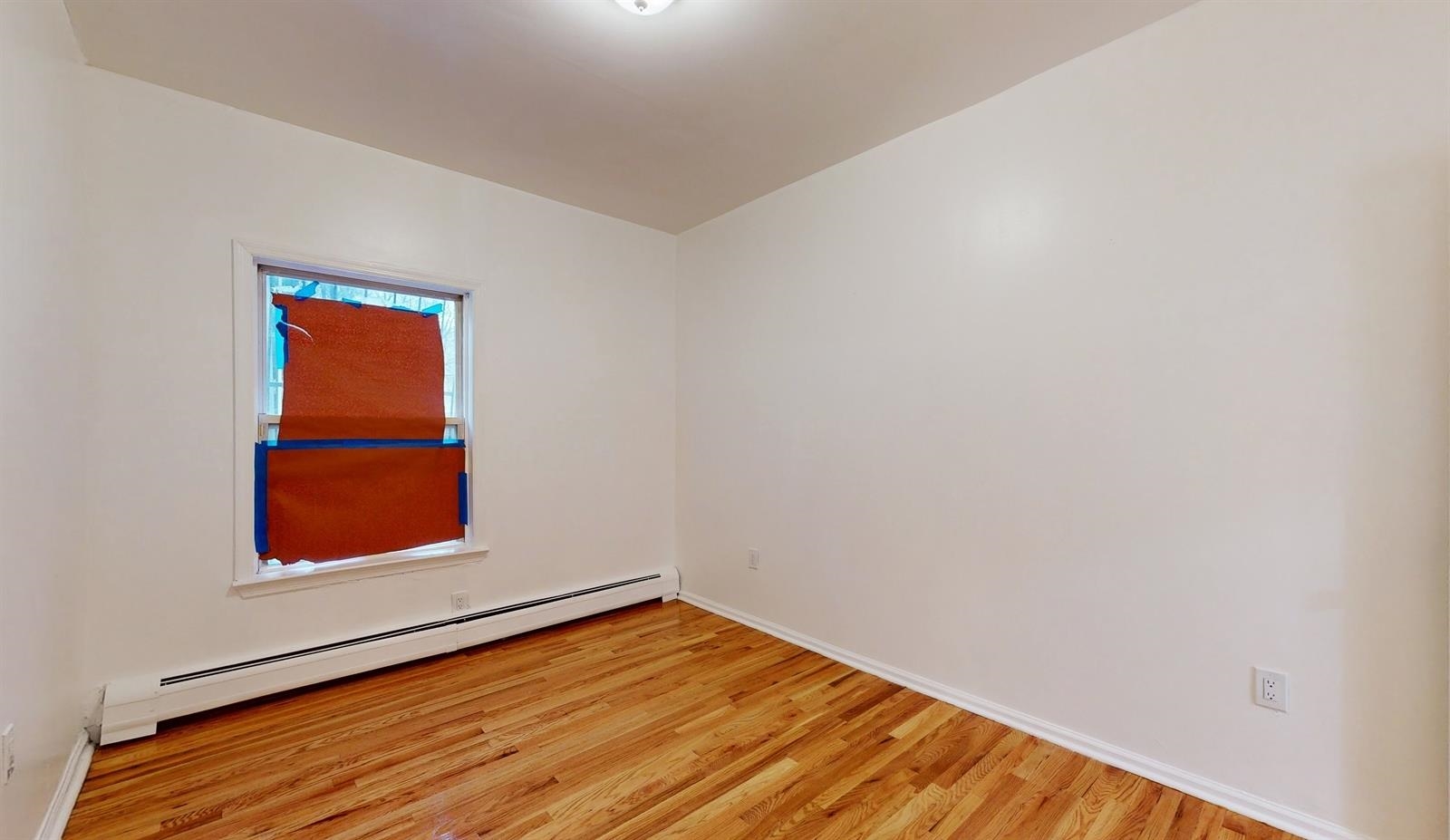 604 4th Street Hoboken, NJ 07030 - Photo 10 of 30 an empty room with wooden floor and a window