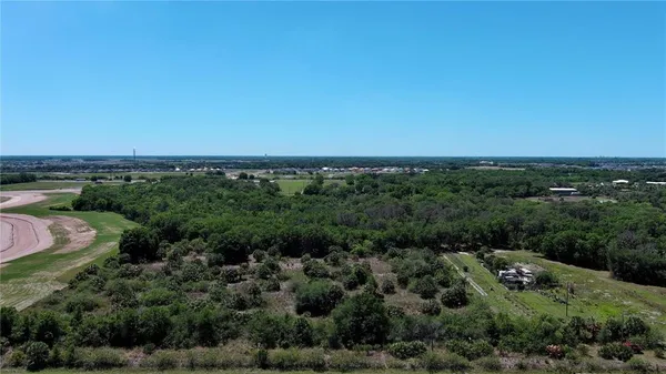 an aerial view of a houses with a yard