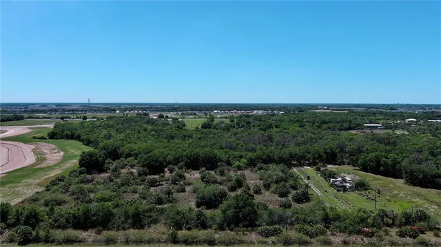 an aerial view of a houses with a yard