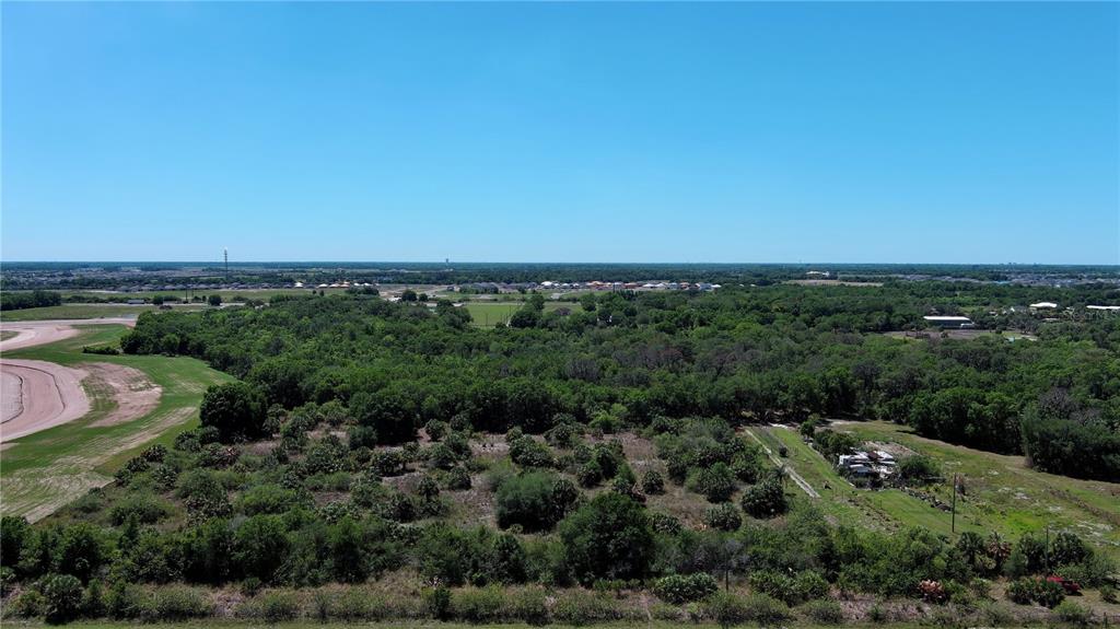 an aerial view of a houses with a yard