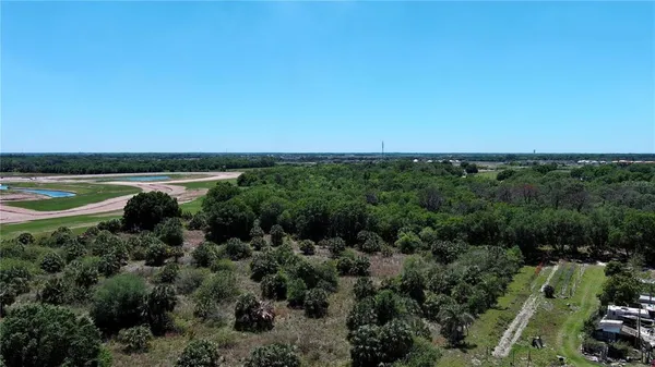 an aerial view of a houses with a yard