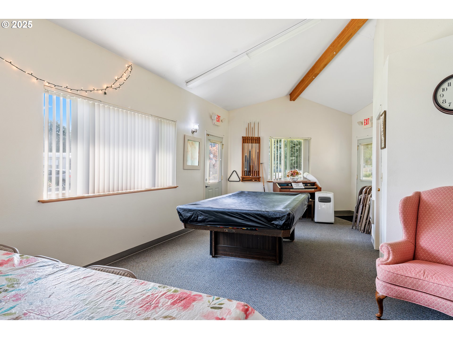 1625 Henderson Avenue Eugene, OR 97403 - Photo 12 of 20 a living room with furniture a bed and a large mirror next to a window