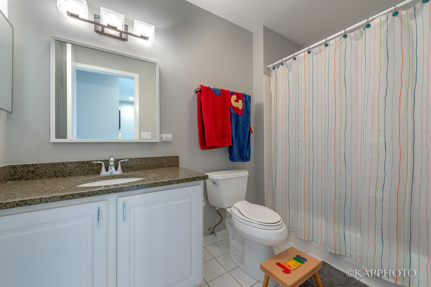 27 North Racine Avenue, Unit 432 Chicago, IL 60607 - Photo 22 of 28 a bathroom with a granite countertop sink and a mirror