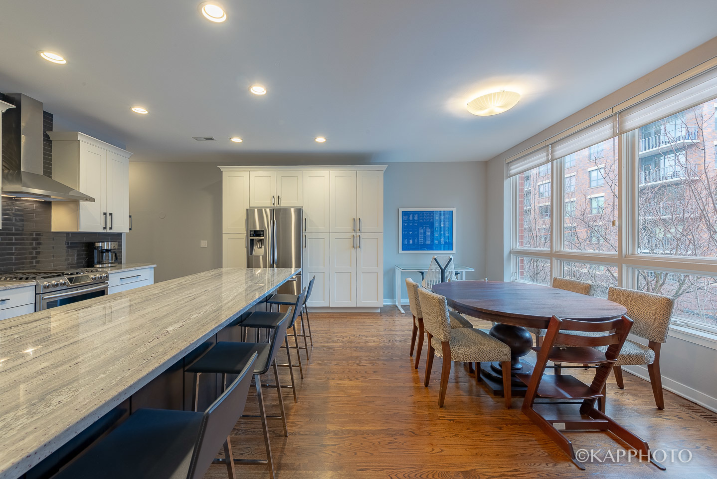 27 North Racine Avenue, Unit 432 Chicago, IL 60607 - Photo 9 of 28 a dining room with stainless steel appliances kitchen island granite countertop a table chairs and a refrigerator