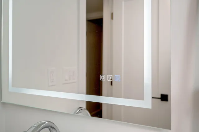 a kitchen with stainless steel appliances kitchen island granite countertop a lot of cabinets and wooden floors